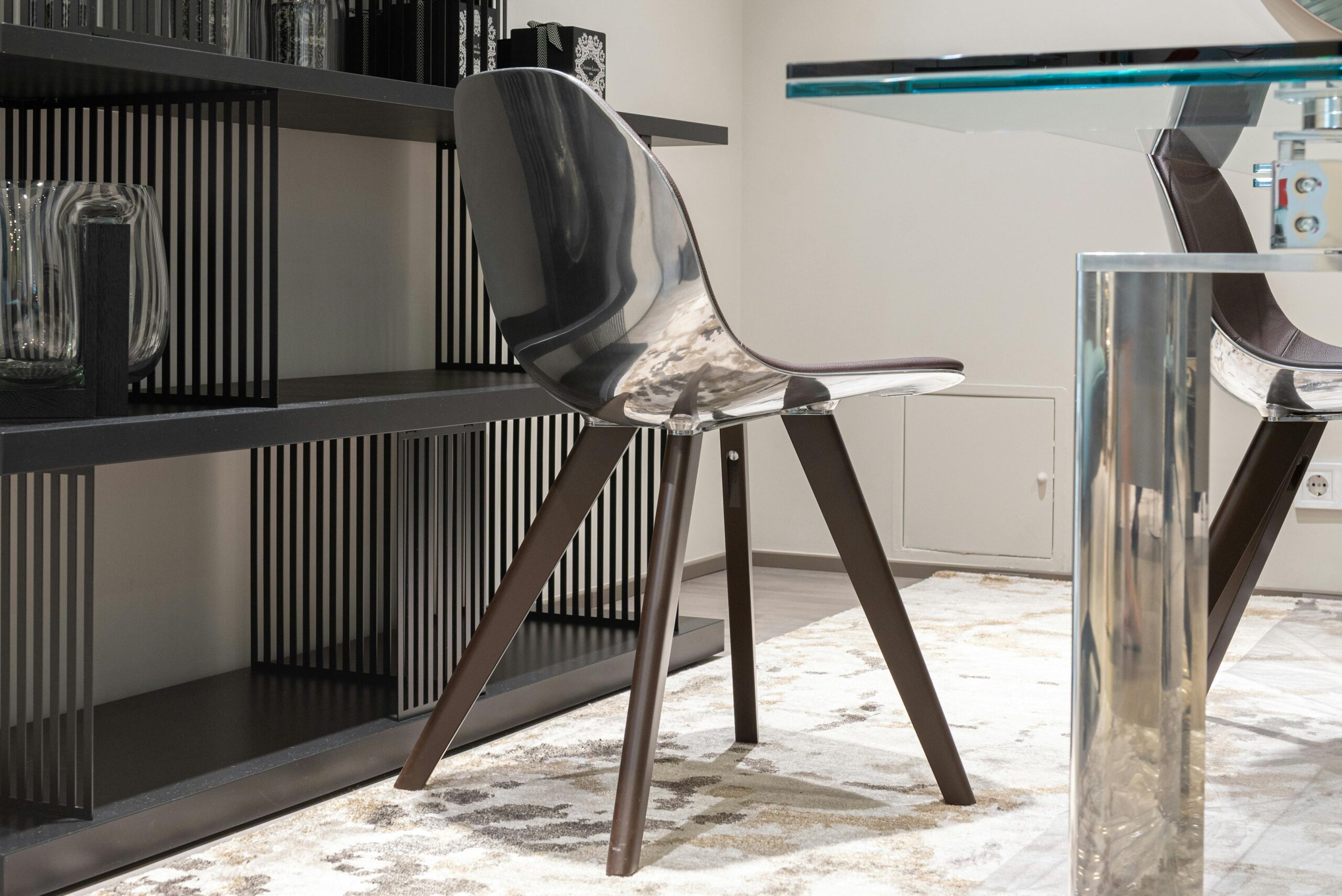 Sleek stainless steel chair with modern design in a stylish indoor setting.